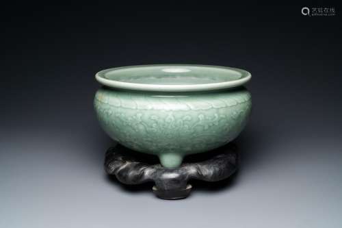 A Chinese celadon-glazed tripod censer with peony scrolls, 1...