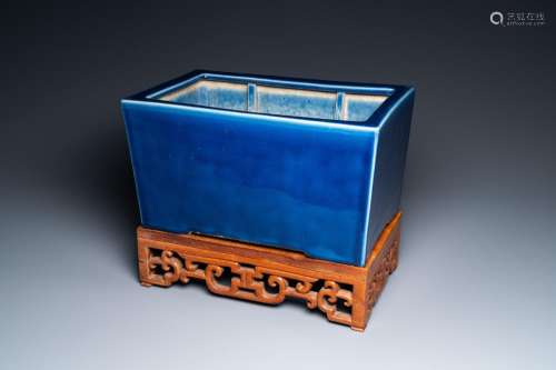 A Chinese rectangular blue-glazed jardiniere on wooden stand...