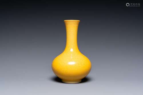 A Chinese monochrome yellow-glazed bottle vase with incised ...
