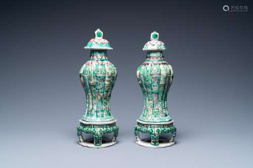 A pair of Chinese verte biscuit vases and covers on stands, ...