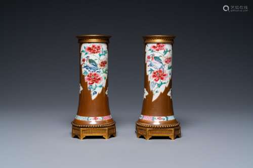A pair of Chinese famille rose vases with gilt bronze mounts...