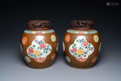 A pair of Chinese famille rose capucin brown-ground jars, Qi...