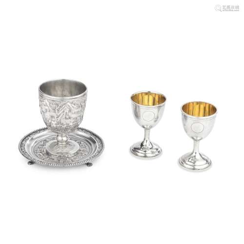 A PAIR OF GILT SILVER WINE CUPS AND A REPOUSSÉ SILVER STEM C...