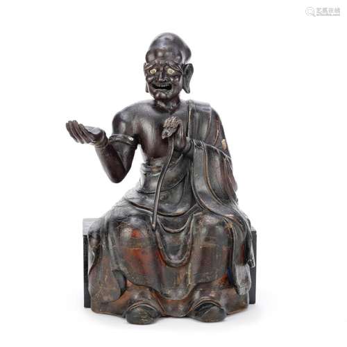 A LARGE LACQUERED WOOD CARVING OF A SEATED LUOHAN Qing Dynas...