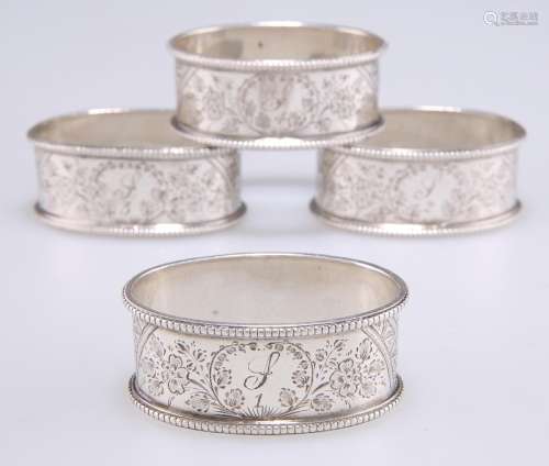 A SET OF FOUR VICTORIAN SILVER NAPKIN RINGS
