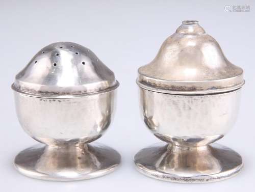 A PAIR OF ARTS AND CRAFTS SILVER SALT AND PEPPER POTS