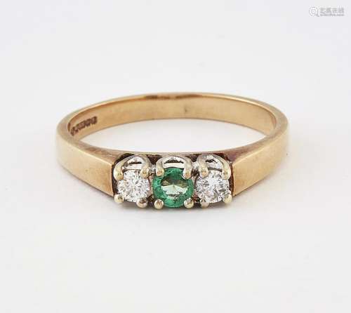 A 9 CARAT GOLD EMERALD AND DIAMOND THREE STONE RING