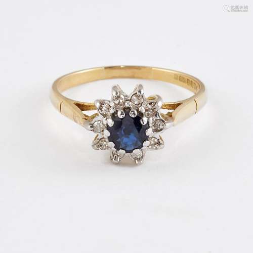 AN 18 CARAT GOLD SAPPHIRE AND DIAMOND CLUSTER RING