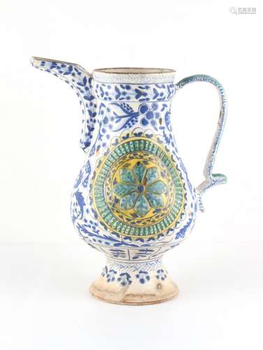 A Turkish Ottoman Kutahya pottery jug, painted in blue with ...
