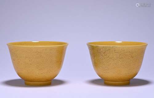 A pair of yellow glazed 'dragon' cup