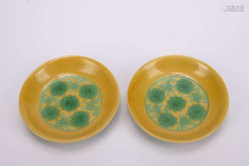 A pair of yellow-ground green glazed 'floral' dish