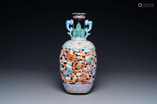 A Chinese famille rose vase with molded design of Buddhist l...
