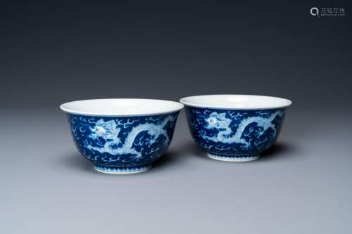 A pair of Chinese blue and white 'dragon' bowls, Kangxi mark...