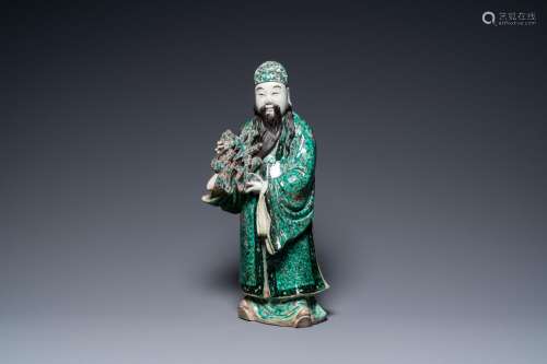 A Chinese verte biscuit figure of an immortal, 19th C.