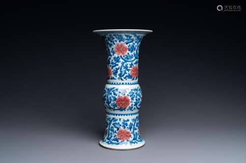 A Chinese blue, white and copper-red 'gu' vase with lotus sc...