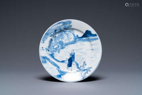 A Chinese blue and white plate with two men in a landscape, ...