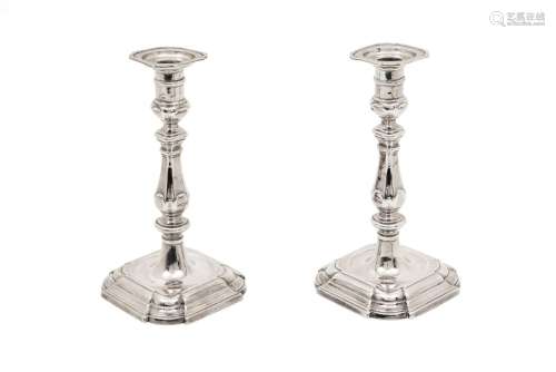 A pair of silver candlesticks on octagonal moulded base