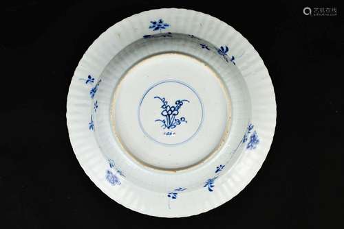 A blue and white porcelain charger with lobed rim, decorated...