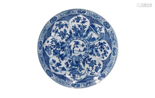 A blue and white porcelain charger, decorated with reserves ...