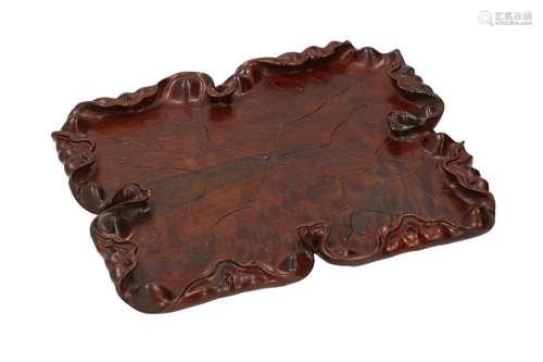 A carved wooden serving tray in the shape of flower