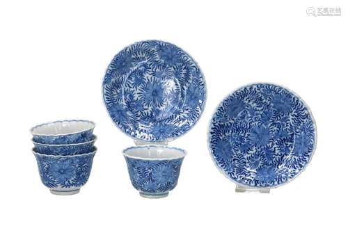 A set of four blue and white porcelain cups with two saucers...