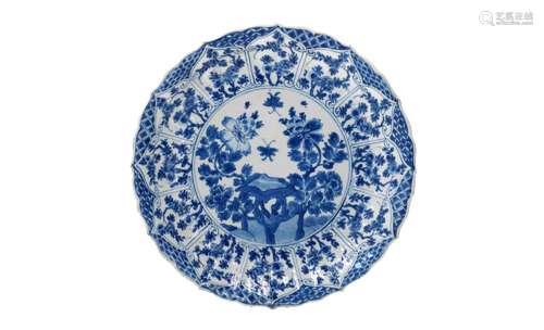 A lobed blue and white porcelain dish with scalloped rim, de...