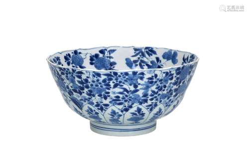 A blue and white porcelain bowl with scalloped rim, decorate...