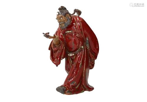 A red glazed Shiwan ware sculpture, depicting the mythologic...