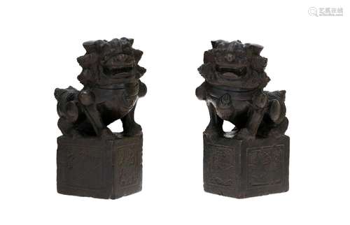 A pair carved basalt sculptures in the shape of Foo dogs