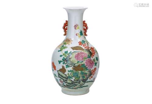 A polychrome porcelain vase with two ears, decorated with fl...