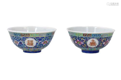 A pair of polychrome porcelain cups, decorated with reserves...