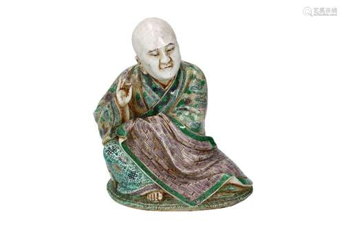 A famille verte porcelain sculpture depicting a seated monk