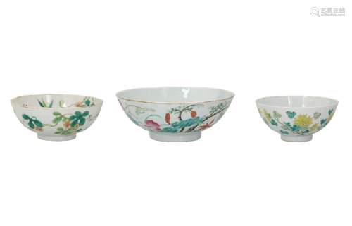 A set of three polychrome porcelain bowls, decorated with fl...