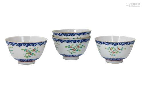 A set of four polychrome porcelain cups, decorated with flow...