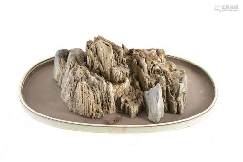 A stone sculpture depicting a rock formation, on Yixing tray...