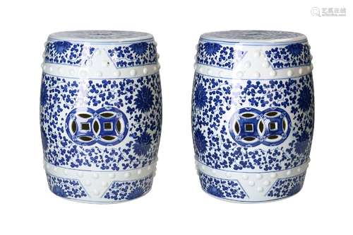 A pair of blue and white porcelain garden seats, decorated w...