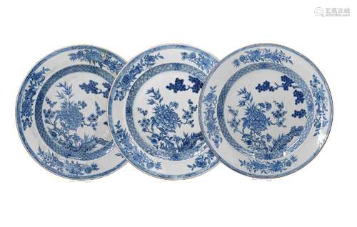 A lot of three blue and white porcelain chargers, decorated ...