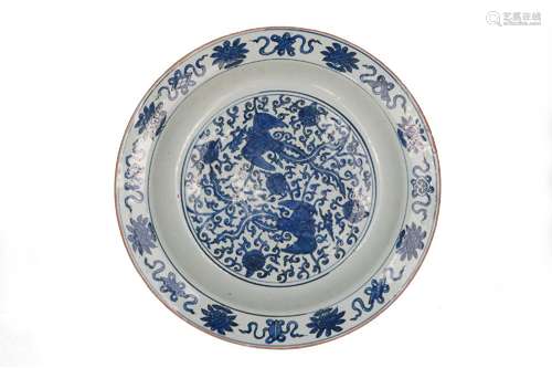 A blue and white porcelain charger, decorated with phoenixes...