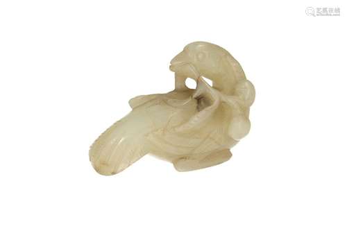 A carved jade sculpture, depicting a bird with a twig in its...