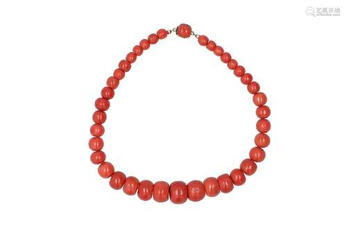 A red coral necklace with 14-kt gold clasp set with red cora...