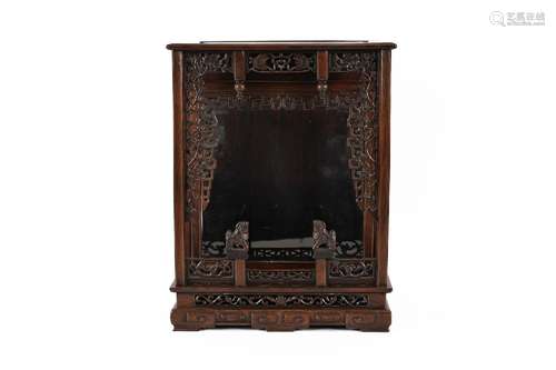 A carved wooden house altar