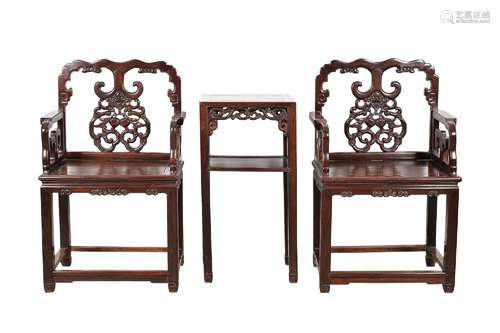 A pair of rosewood armchairs and a table