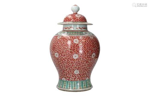 A polychrome porcelain lidded vase, decorated with flowers