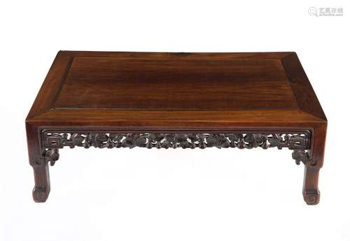 A carved Huali Kang table, decorated with flowers