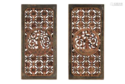 A pair of carved polychrome wooden panels, depicting flowers...