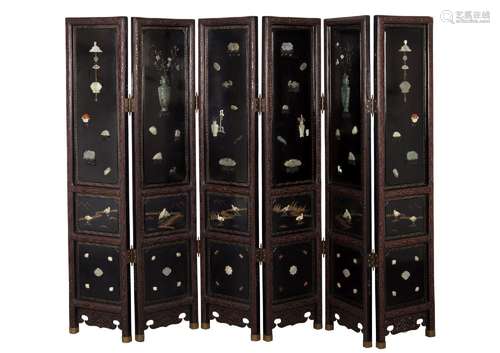 A black lacquered folding screen consisting of six panels wi...