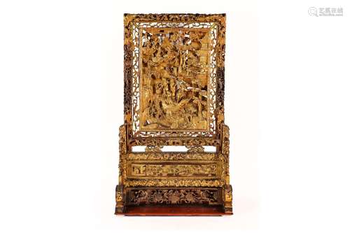 A carved and gilded wooden table screen, depicting 'The jour...