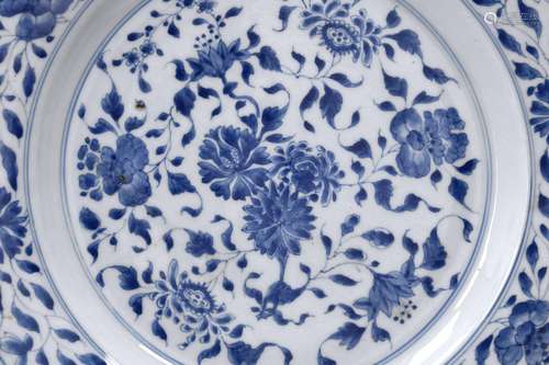 A blue and white porcelain charger, decorated with flowers