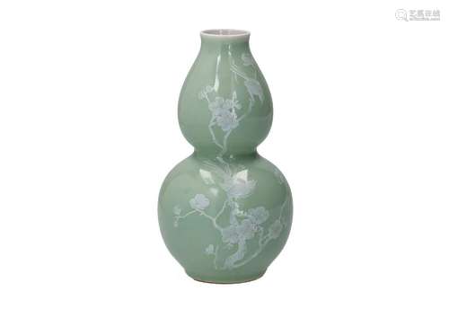 A yellowish pea green glazed double gourded vase, with white...