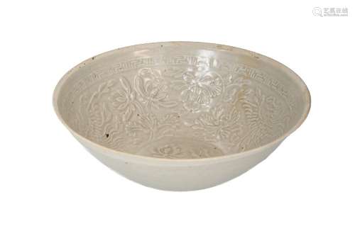 A Ding Yao ware bowl with relief decor of flowers and phoeni...